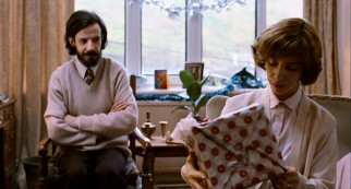 Lloyd (Noah Taylor) musters what little emotion he can as his wife (Sally Hawkins) opens one of his Christmas gifts for her.