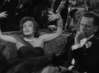 Norma Desmond (Gloria Swanson) and Joe Gillis (William Holden) get different amounts of enjoyment out of her private New Year's Eve party for two.