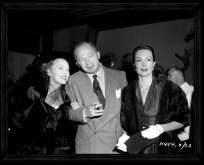 Billy Wilder stands next to his leading lady Gloria Swanson in this photo gallery image.