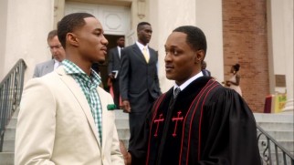 Cam (Jessie T. Usher) speaks with a pastor (Javon Johnson) following an exploratory church service.