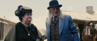 A scene-stealing Ed Harris plays the new sheriff Cornelius Jackson, who here does some investigating of a peephole death.