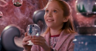 Lucy (Liliana Mumy), the preteen daughter of Scott's ex-wife and her new husband, rises in prominence with her warm hugs and snowglobe appreciation.