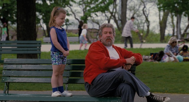 A little girl approaches the jolly fat man in red (Tim Allen) trying to watch his son's soccer game in "The Santa Clause."