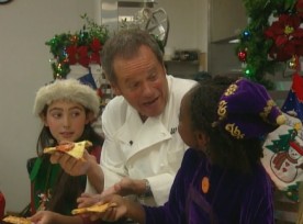 Wolfgang Puck teaches kids how to make pizza for Santa Claus.