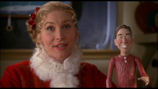 In this alternate opening, Mrs. Claus (Elizabeth Mitchell) teaches her elf pupils about the first film, using a Scott Calvin figure to demonstrate his changes.