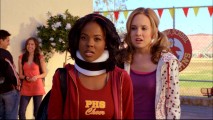 Chastity (Dana Davis) is surprised to learn that the new student that put her in a neck brace is related to the aspiring cheerleader on her left.