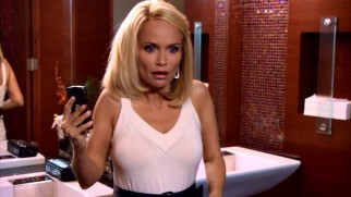 Ho ho no! Christmas is ruined when E.J. Baxter (Kristin Chenoweth) catches her fiancé and her boss getting friendly in a bathroom stall.