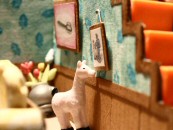 A llama adjusts a framed wall picture of he and his owner in Isabela Dos Santos' contest-winning stop-motion short "Obsessive Compulsive."