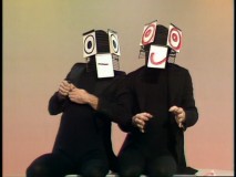 Mummenschanz put on one of their odd acts. Just what is their story?!