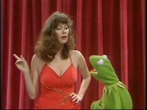 Lesley Ann Warren makes a point to Kermit outside the Muppet Theater's famous red stage curtain.