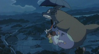 Totoro takes the girls on an exhilarating flight over the Japanese countryside, letting out a powerful roar.