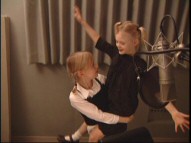 Dakota Fanning carries younger sister Elle around the studio and "Behind the Microphone."