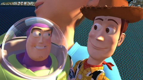 Safe in Andy's arms, Buzz and Woody sneak a knowing glance at each other.