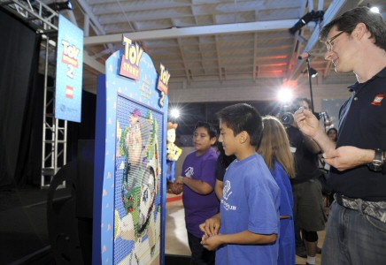 Lego Master Builder Erik Varszegi assists Boys & Girls Clubbers on filling in Buzz.