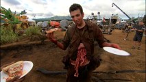 Though his guts would appear to be pouring out, Jay Baruchel still enjoys a slice of pizza with a smile in "The Hot LZ."