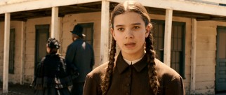 Pigtailed precocious 14-year-old protagonist Mattie Ross (Hailee Steinfeld) searches for a bounty hunter to serve justice to her father's murderer.