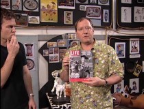 John Lasseter shows off an old issue of Life magazine, one of many cool "Woody's Roundup" props created purely for TS2.