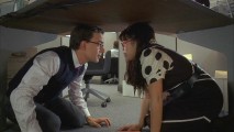 Henry (Christopher Gorham) and Betty hide their relationship under an office table as "Something Wicked This Way Comes."
