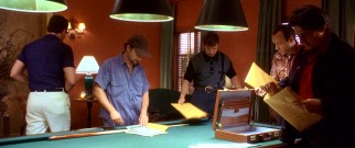 The Usual Suspects check out the incriminating evidence against them they have just received from a representative of feared and fabled criminal mastermind Keyser Sze.