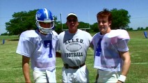 With his T-shirt paying homage to his previous football coordinating film credit "The Waterboy", Mark Ellis extols the athletic values of pretend quarterbacks Paul Walker and James Van Der Beek in "Two-a-Days."