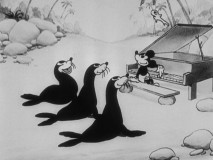 Mickey tickles the keys for some seals in "The Castaway."