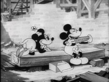 After giving him a free box lunch, Minnie admires Mickey's corn-eating skills in "Building a Building."
