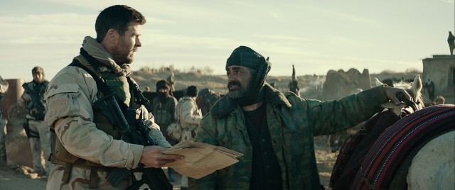 Captain Mitch Nelson (Chris Hemsworth) consults with General Dostum (Navid Neghaban) in "12 Strong."