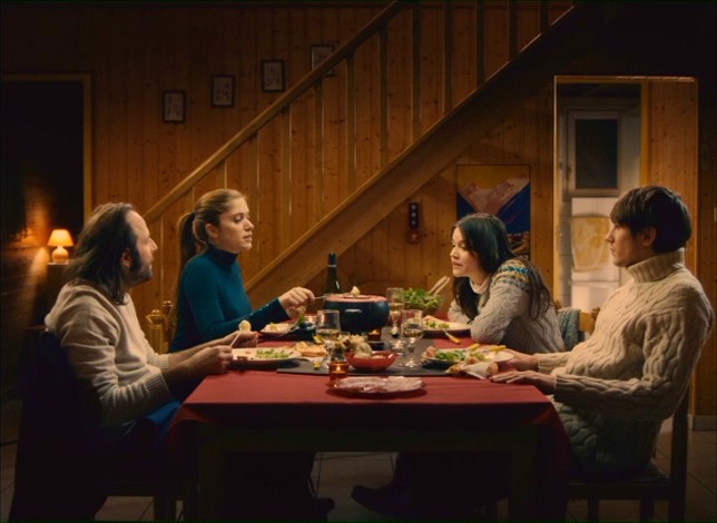 On a shared winter vacation, the four lead characters enjoy fondue.
