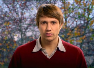 In front of a scenic fall backdrop, Benjamin (Bastien Bouillon) recalls his startling stroke experience in a reality TV-style direct camera address.