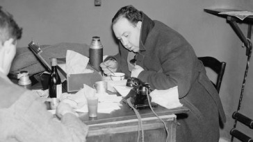 A photo of Alfred Hitchcock huddled among tissues, soup, and a telephone features in the Leonard Leff visual essay "The Borders of the Possible."