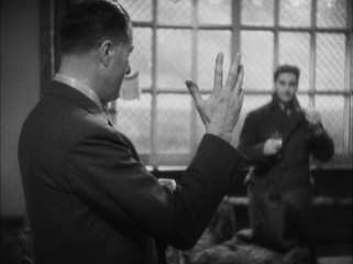 Hannay is surprised to learn that the man he was searching for (Godfrey Tearle) is the same partially pinkied professor he was warned to avoid.