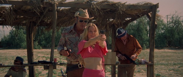 The new and improved Pinky Rose (Sissy Spacek) takes shooting range target practice with cowboy Edgar (Robert Fortier), much like Millie did before her.