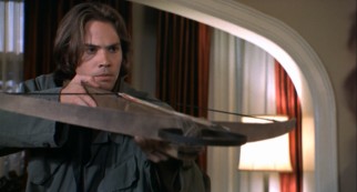 Luke Churner (Barry Watson) aims the crossbow.