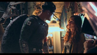 Megan Fox acts across from a man in a gray motion capture half-shell as part of our "Digital Reality."