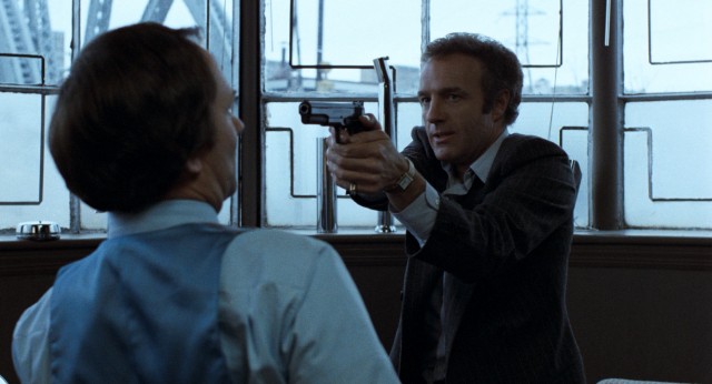 Frank (James Caan) proves he's not monkeying around by pointing a gun at the plating company executive who owes him money.