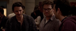 Housewarming host James Franco asks Jay Baruchel about art, while Seth Rogen looks directly into the camera.