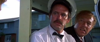 Eddie Goody (Geoffrey Lewis) and Red Leary (George Kennedy) have some words for a kid who questions their mini ice cream truck's route.