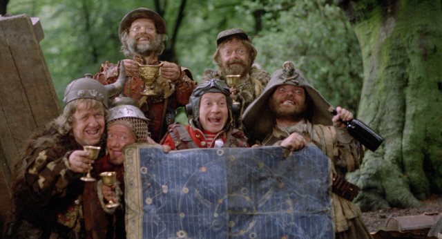 The Time Bandits take group photo with stolen treasures and the map they use to travel through time.