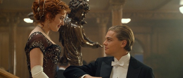 Fixed up for his meal in first class, Jack Dawson (Leonardo DiCaprio) extends a forearm to Rose DeWitt Bukater (Kate Winslet).