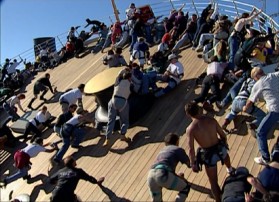 Casually-dressed stunt performers work out how they will fall once the ship set is tilted in this "Behind the Scenes" short.
