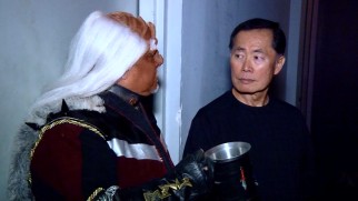 A fan dressed in a Star Trek costume casually chats up George Takei in this extended scene.