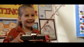 A young Casey shows off her mind at a science fair in this deleted scene.