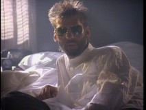 With sunglasses and a wrinkled oversized shirt, Kenny Loggins looks very... dangerous in his "Danger Zone" music video.