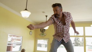 A sandwich spear is a dangerous weapon in the hand of Harland Williams.