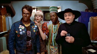 Louis (Dan Aykroyd), Ophelia (Jamie Lee Curtis), Billy Ray (Eddie Murphy), and Coleman the butler (Denholm Elliott) play dress-up as part of their climactic New Year's Eve train ride scheme.