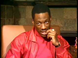 A young Eddie Murphy bites his nails while candidly answering a reporter's questions in 1983.
