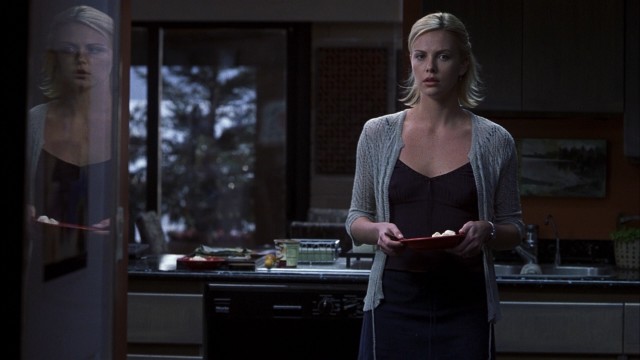 In the 2002 thriller "Trapped", Karen Jennings (Charlize Theron) and her reflection sense something amiss while dishing out ice cream.