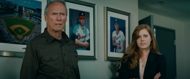 The father scowls, the daughter smiles. Together, Clint Eastwood and Amy Adams are... the baseball family!