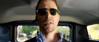 Like Howard, rival agent Aldo Stankis (Sam Rockwell) is typically found with Bluetooth in one ear and a stud earring on the other.