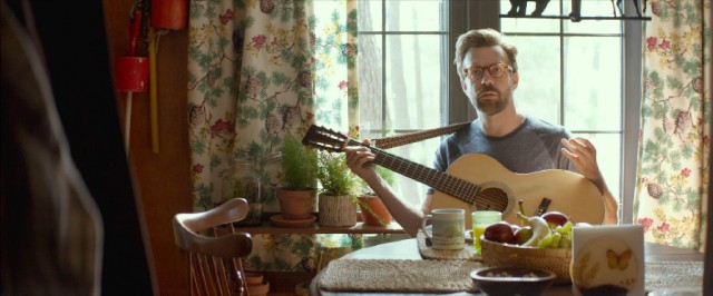Pop culture professor Andrew McCabe (Jason Sudeikis) plays a little guitar.